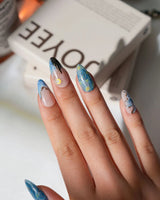 Starry Night L press-on nails in medium almond with blue night sky and gold star accents