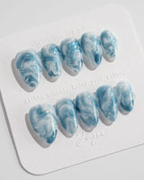 Starry River extra short almond nails with aqua marble swirls and silver shimmer