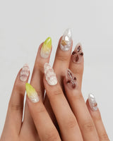 Sun Fossil medium almond nails with toffee, dusty rose and cream sea textures