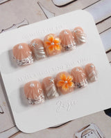 Sunset Shore extra short coffin nails with nude orange florals and coastal shell texture
