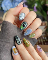 Mindbend abstract retro nails with green grid pattern, shifting shapes, and sculpted chrome detail