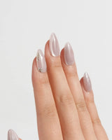 Sweet Nothings press-on nails in short almond shape — Soft Nude Pink, Glitter Accents, Metal Heart & Silver Flowers.