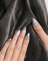 The Cygnus nail art close-up showing silver lilac cat eye feather chrome rhinestone cat eye effect details