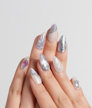 The Cygnus handmade press-on nails featuring silver lilac cat eye feather chrome rhinestone cat eye effect