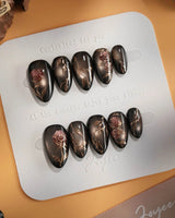 Thorned Spell press-on nails — black cat eye gold outline rose thorn design handmade nail art by Joyee Nails