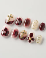 Tip Burgundy Nails in extra short oval shape with burgundy French tips and floral accents