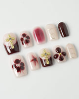 Tip Burgundy Nails in short square shape with burgundy French tips and floral gold details