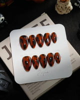 Tortoise handmade press-on nails in extra short almond shape by Joyee Nails