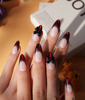 Vampire Lace press on nails with blood red French tips, hand-painted black lace trim and a 3D black bow on a nude base - image 1