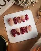 Velvet Flow press-on nails with deep red velvet shimmer and sculpted butterfly wing details
