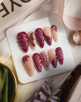 Velvet Flow medium stiletto press-on nails with sultry berry red shimmer and butterfly accents