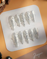 Velvet Frost press-on nails in medium stiletto shape — 3D Spiral Texture, Silver Glitter Effect.