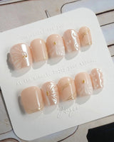 Venus extra short coffin nails with pearl nude shell art and gold accents
