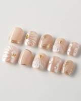 Venus extra short squoval nails with pearly shell art and gold accents