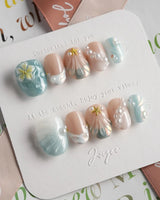 Yasawa Blue starlit shore nails with blue-white shimmer, pearls, and sculpted shells
