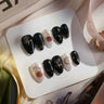 Baroque Noir black and gold press-on nails with ornate baroque pattern on almond shape — luxury black-and-gold nail art handmade by Joyee Nails.