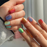 Colorful short squoval press-on nails with bright mixed summer shades — the universally flattering squoval nail shape shown on natural hands, handmade by Joyee Nails.