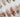 White press-on nail designs from Joyee Nails — milky white, pearl white, chrome white, and bridal French tip styles arranged on a neutral background