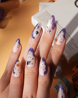 Witching Hour press on nails with a black spider web, bats, ghost, black cat and jack-o'-lanterns on a nude base with purple glitter edges - image 1