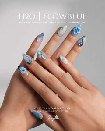 Bali Blue island floral nails with hand-painted waves and shimmering blue petals