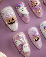 Hallow’s Eve nail art close-up showing sheer pink base iridescent glitter ghost pumpkin 3D accents rhinestone mix details