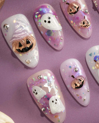 Hallow’s Eve nail art close-up showing sheer pink base iridescent glitter ghost pumpkin 3D accents rhinestone mix details