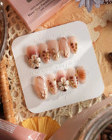 Caramel Cream nail set with warm brown theme, 3D flowers, and delicate gold wire art