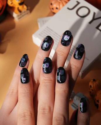 Party Spirits press on nails with holographic teal, lilac and pink glitter ghosts on a glossy black base - image 4
