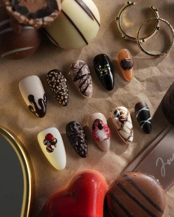 Close-up of Chocolate Box press-on nails with raised chocolate pieces and dessert-style gel texture
