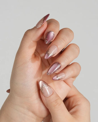 Caramel Petal press-on nails with warm mauve chrome tips, nude base and gold gel details