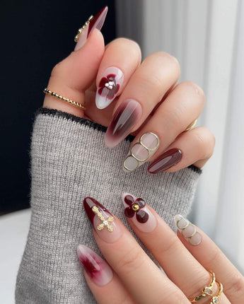 Burgundy gold medium almond press on nails with floral petals and cross charms