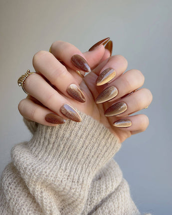 Light Brown Cat-eye nails in short almond shape with neutral brown magnetic shimmer