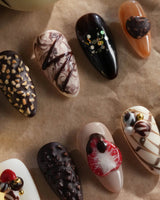 Chocolate Box press-on nails with realistic 3D chocolate dessert pieces and glossy gel finish
