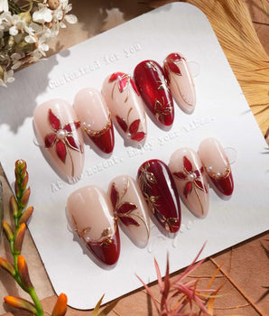 Crimson Petals handmade press-on nails featuring deep red french tips nude base gold outline floral