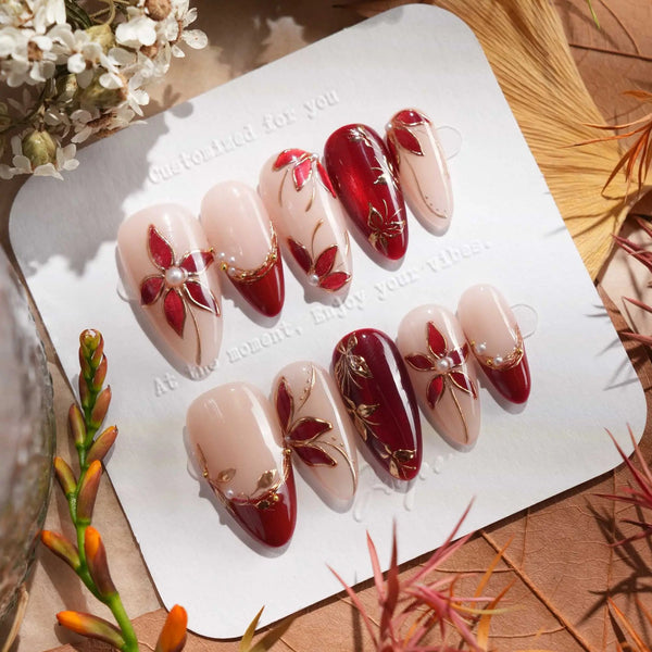 Crimson Petals red cat eye fall nails with gold floral accents