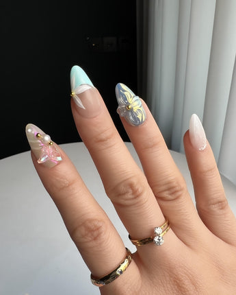 Aqua Petal handmade nails with pastel aqua shimmer, flowers, and delicate butterfly detail
