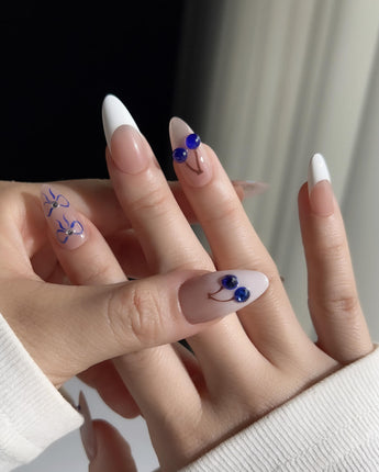 Klein Blue Cherry almond nails with modern cobalt fruit details on French tips