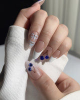 Close-up of Klein Blue Cherry showing glossy white tips and vivid blue cherry details