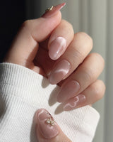 Thump Bunny pink press-on nails with heart-shaped cat-eye highlights