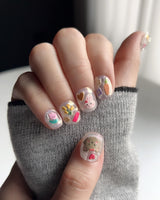 Squishy Pop reusable press-ons with fun pop-art details on extra short squoval nails