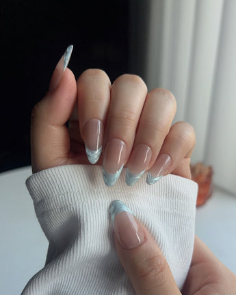 Close-up of Sea Salt showing delicate icy blue French tip nail art