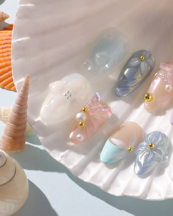 Aqua Petal close-up of 3D butterfly and floral details on pearly pastel nails
