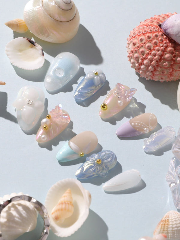 Aqua Petal short almond nails with pearly pastels, 3D flowers, and butterfly accents