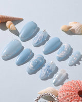 Close-up of Mermaid Nail Designs Tale with 3D waves, shells, and airy blue gel polish