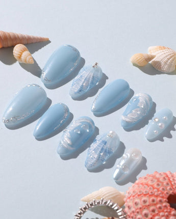 Close-up of Mermaid Nail Designs Tale with 3D waves, shells, and airy blue gel polish