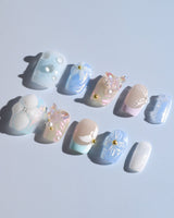 Aqua Petal delicate pastel manicure with sculpted flowers, butterflies, and pearly shine