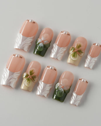Duchess Olive nail close-up with olive French styling and dimensional flower details