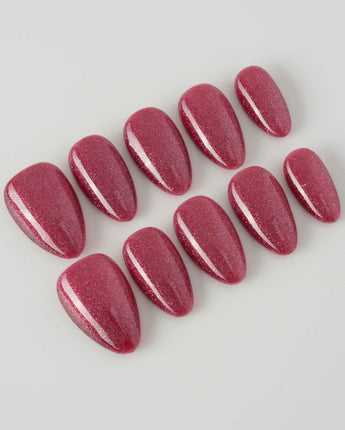 Ruby Red Cat-eye press-ons with burgundy red shimmer and polished fall nail art