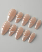 Dew Sparkle nails with nude French styling, glossy finish, and pearly accent details