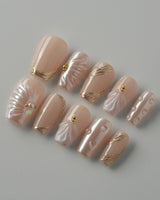 Venus pearly nude 3D shell nail set with glossy gold-accented details